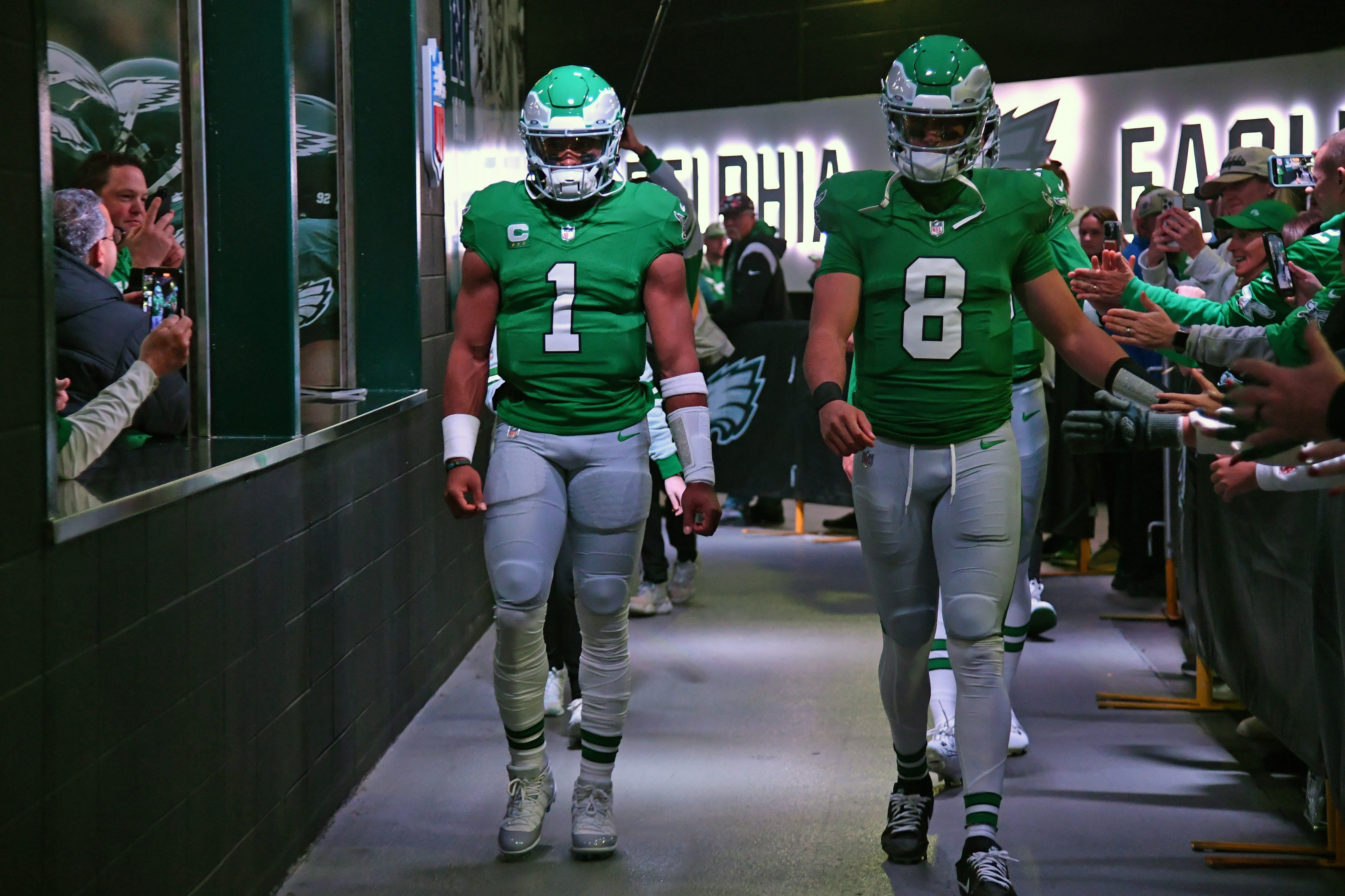 Philadelphia Eagles quarterback Marcus Mariota (8) walks through the tunnel with quarterback Jalen Hurts (1) ahead of a game against the Miami Dolphins.